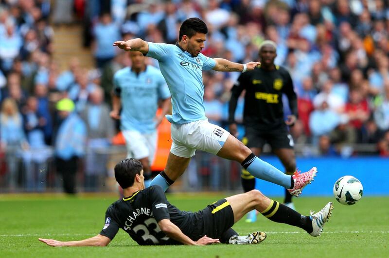 LONDON, ENGLAND - MAY 11:  Sergio Aguero of Manchester City  evades the challenge from Paul Scharner of Wigan Athletic during the FA Cup with Budweiser Final between Manchester City and Wigan Athletic at Wembley Stadium on May 11, 2013 in London, England.  (Photo by Alex Livesey/Getty Images)