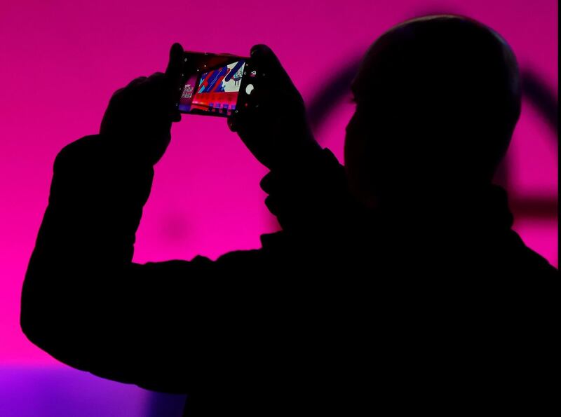epa06568921 A visitor takes a picture with his smart phone on the second day of the the Mobile World Congress (MWC) in Barcelona, Spain, 27 February 2018. The MWC presents the latests advances in mobile technologies and will be held from 26 February to 01 March 2018.  EPA/Andreu Dalmau