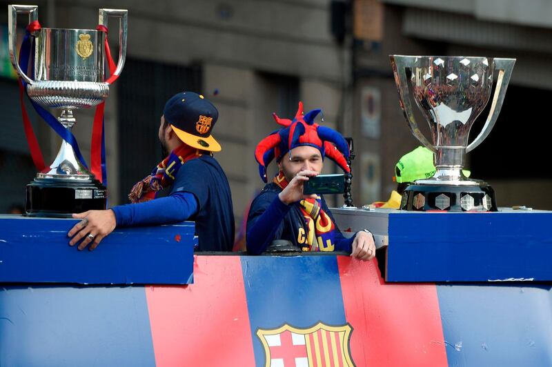 Andres Iniesta takes pictures atop the Barceona bus during the title celebrations. Lluis Gene / AFP