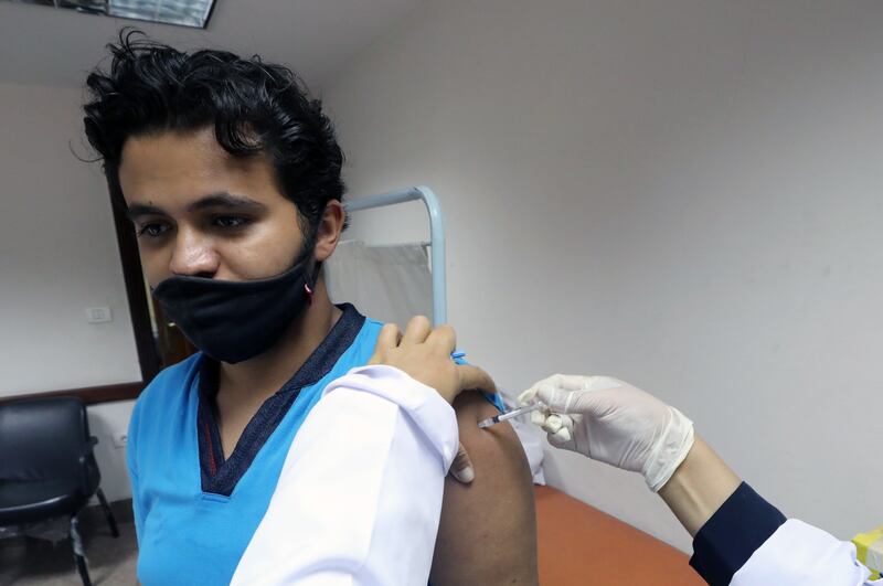 A health worker inoculates a student against at a vaccination centre at Cairo University. EPA