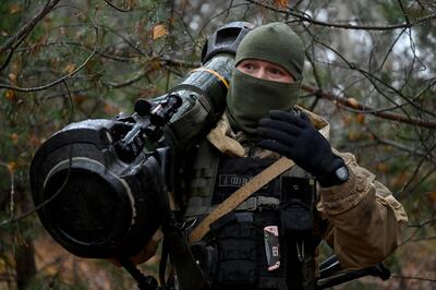 A Ukrainian border guard carries an NLAW donated by the UK. AFP
