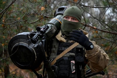 A Ukrainian border guard carrying an NLAW. AFP