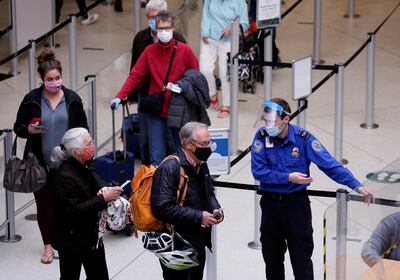 FILE PHOTO: A TSA worker directs travelers to the next station at a security checkpoint at Seattle-Tacoma International Airport in SeaTac, Washington, U.S. April 12, 2021.  REUTERS/Lindsey Wasson/File Photo