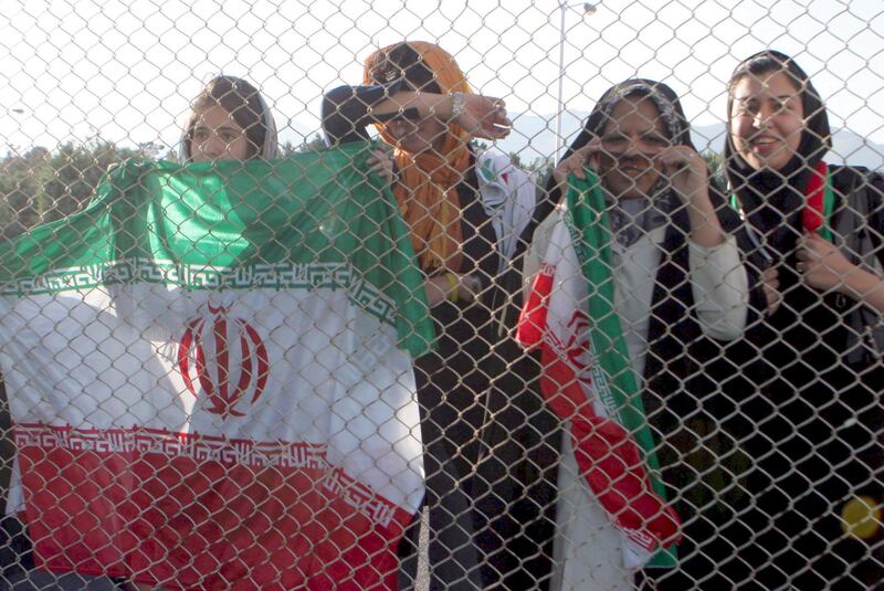 epa00719400 Female Iranian football fans watching from a distance as the Iranian national football team train in Tehran, after hundreds of women were barred  Monday  22 May 2006 from entering the training camp.  Iranian women soccer fans are devastated following a decision by Iran's Supreme Leader that women are not allowed to watch men's soccer games in person. This decision comes just a month after Iran's President said women are allowed to watch soccer matches at stadiums.  EPA/Abedin Taherkenareh *** Local Caption *** 00719400