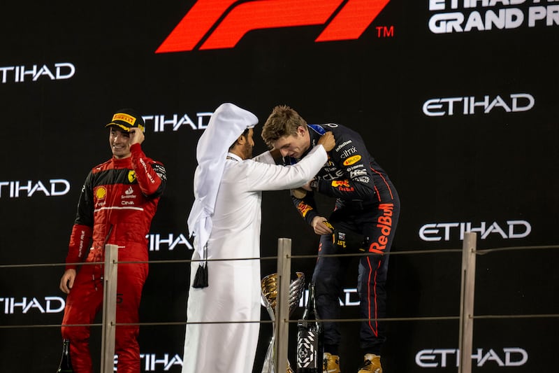 Mohammed Ben Sulayem, president of the FIA presents a medal to Max Verstappen, winner of the 2022 Formula 1 Etihad Airways Abu Dhabi Grand Prix, on November 20, 2022. AP Photo