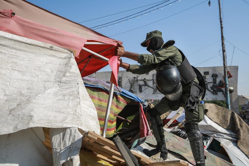 31 October 2020, Iraq, Baghdad: A soldier removes tents of anti-government protesters at Tahrir Square, as security forces reopen it after a closure that lasted more than a year due to anti-government protests. Photo: Ameer Al Mohammedaw/dpa (Photo by Ameer Al Mohammedaw/picture alliance via Getty Images)