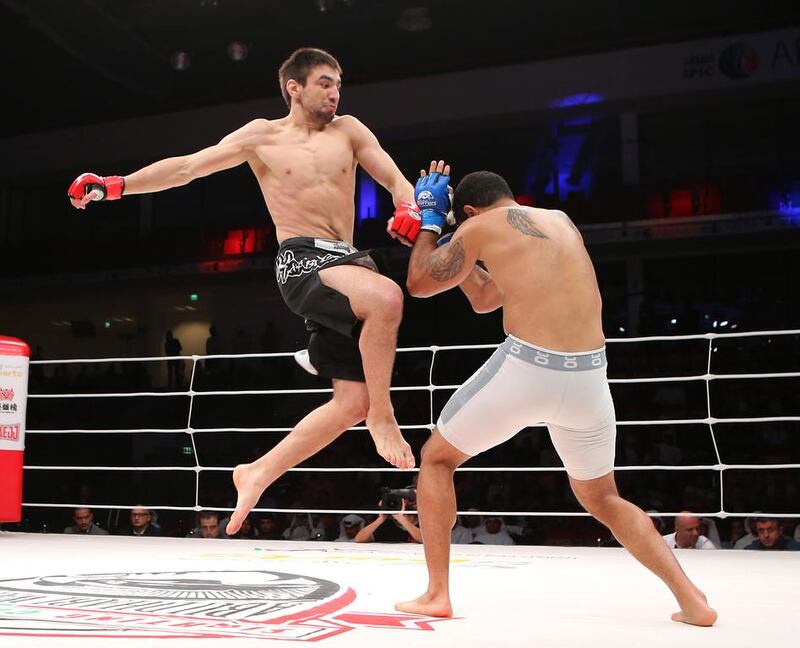 Jason Santana from US, in white shorts, fights with Pavel Gordeev from Russia in the Abu Dhabi Warriors 4 at IPIC Arena in Zayed Sports city in Abu Dhabi. Ravindranath K / The National