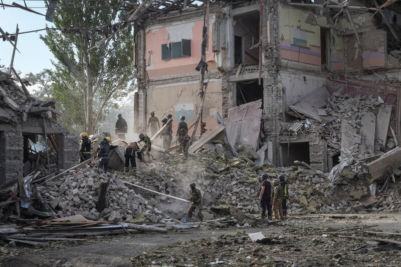 Rescuers and servicemen work at a school building damaged by a Russian military strike in Kramatorsk. Reuters