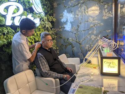 A staff member attending a customer at Oxy Pure, an oxygen bar at Select Citywalk mall in New Delhi on Saturday. Taniya Dutta for The National