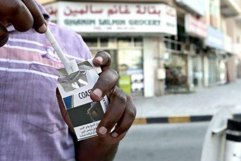 Some individuals still smoke outside their homes in Sharjah, despite a recent municipal ban.  Jeffrey E Biteng / The National
