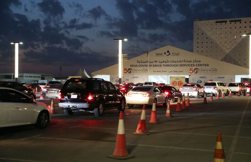 Motorists queue at a drive-through Covid-19 testing facility at City Walk, Dubai. Chris Whiteoak / The National