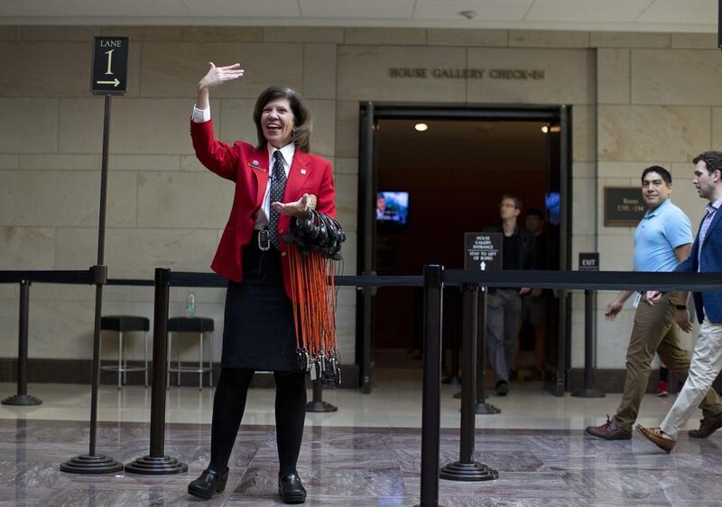 Capitol Visitor Center tour guide Mary Ellen Anderson calls over a group of visitors for the start of a tour on Capitol Hill after reopening. Evan Vucci / AP





