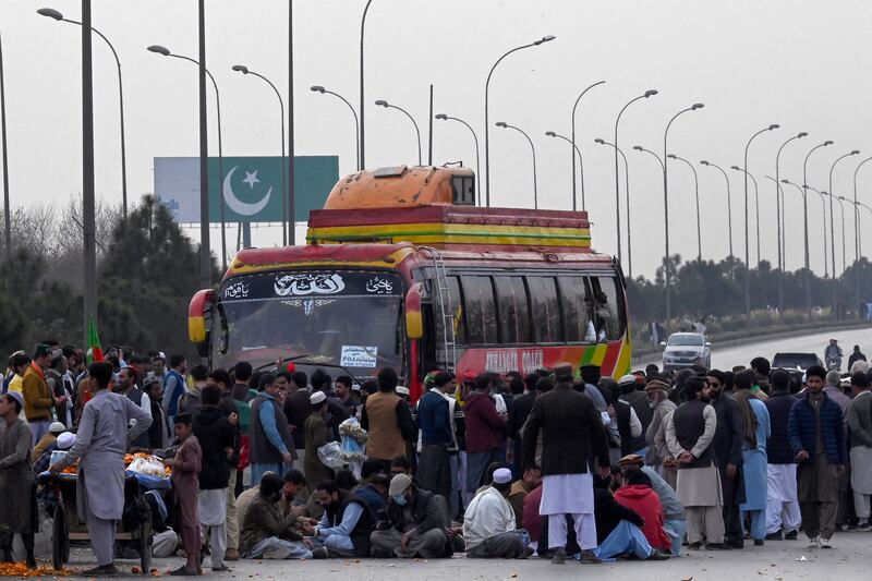 Supporters of former prime minister Imran Khan's Pakistan Tehreek-e-Insaf (PTI) party block the Peshawar to Islambad highway. AFP