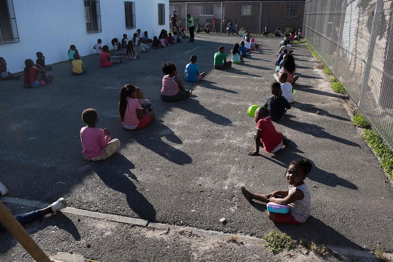 Children wait in lines at a crèche in Langa, near Cape Town. AFP