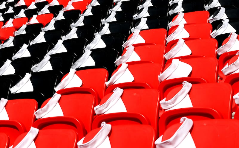 Caps are placed on spectators' seats before the Fifa World Cup match between Japan and Costa Rica in Doha, Qatar. EPA


