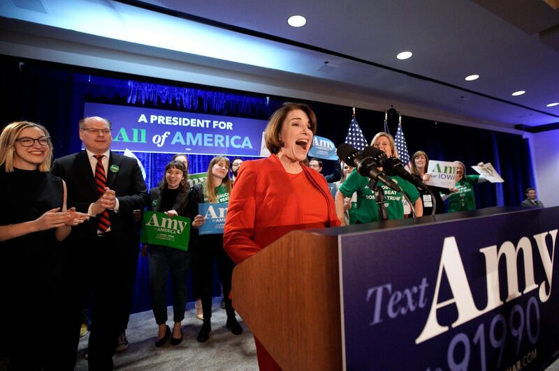Democratic presidential candidate Amy Klobuchar speaks to supporters as she is accompanied by her husband John Bessler, second left, and daughter Abigail Klobuchar Bessler, left, at her caucus night campaign rally in Des Moines, Iowa. AP Photo