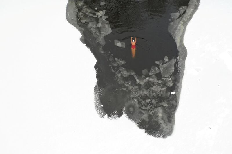 A winter swimmer in a frozen river at a park in Shenyang, Liaoning province, China. Reuters