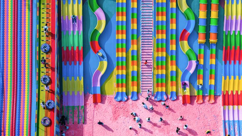 TOPSHOT - This aerial photo taken on October 29, 2023 shows people playing at a playground in China's southwestern Chongqing municipality.  (Photo by AFP)  /  China OUT