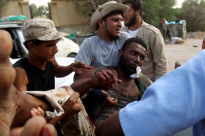 An anti-Gaddafi fighter is being taken to a field hospital in Herawa after he was injured during clashes with Gaddafi loyalists, around 50 km (31 miles) east of Sirte September 20, 2011. In the latest reverse in weeks of chaotic fighting over Sirte, Muammar Gaddafi's birthplace and one of the last remaining bastions of his support, five anti-Gaddafi fighters were killed on Tuesday after they came under artillery fire. REUTERS/Asmaa Waguih (LIBYA - Tags: POLITICS CIVIL UNREST CONFLICT) *** Local Caption ***  BG106_LIBYA-_0920_11.JPG