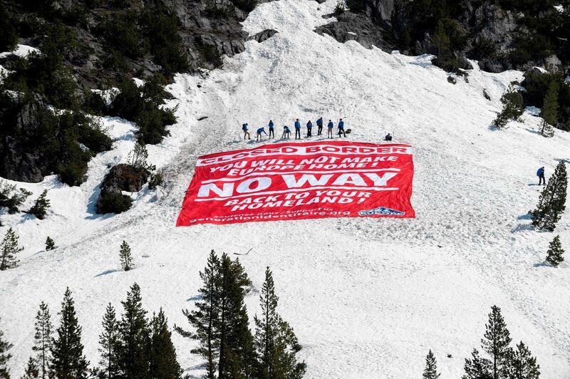 (FILES) In this file photo taken on April 21, 2018 activists from the French far-right political movement Generation Identitaire (GI) and European anti-migrant group Defend Europe conduct an operation titled "Mission Alpes" to control access of migrants using the Col de l'Echelle mountain pass in Nevache, near Briancon, on the French-Italian border. Three activists of Identity Generation (GI) received a six-month prison sentence on August 29, 2019 at Gap Courthouse for their action against migrants at the Col de l'Echelle mountain pass, a crossing point in the French Alps. / AFP / ROMAIN LAFABREGUE
