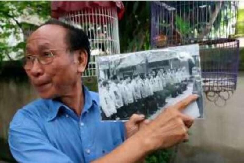 TO GO WITH US-vote-Vietnam-military-McCain,FEATURE by Frank Zeller

Tran Trong Duyet, 74, former Hoa Lo prison director, points at himself in a photograph speaking in front of captured US pilots before they were released in 1973, at his home in Hai Phong on June 27, 2008.  Duyet described US presidential candidate and former prisoner of war John McCain, as "frank and humorous" with "a strong personality" and said they became friends.   AFP PHOTO/Frank ZELLER