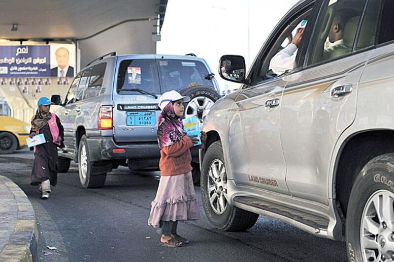 Hamas Hajiri, 8, and her sister Yasmin, 10, sell tissues to passing drivers at the Safia traffic junction in Sanaa’s city centre.