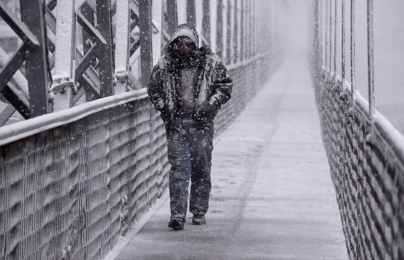 A man walks amidst a snow storm in Iraq's northern city of Mosul.  AFP