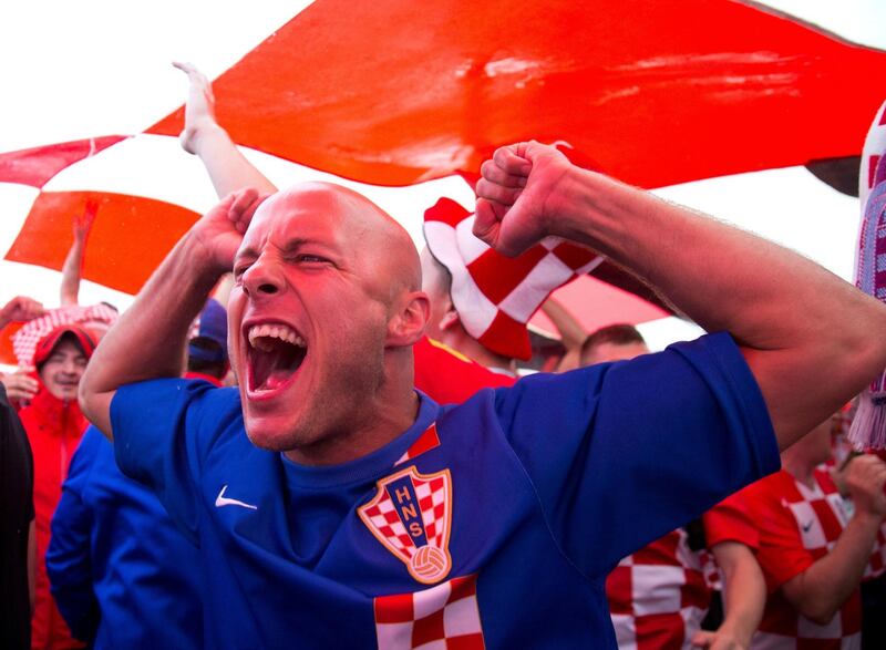 Croatia soccer fans cheer under a giant Croatian national flag at Manezh Square. AP Photo