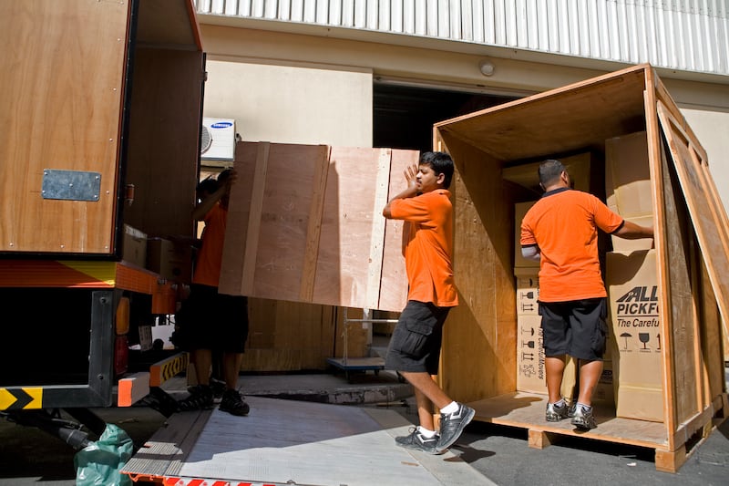 Dubai, UAE - June 4, 2009 - Movers load boxes into a truck to be shipped overseas by Allied Pickfords. Some shipping companies are busier than usual due to expatriate families leaving Dubai during the summer months. (Nicole Hill / The National) *** Local Caption ***  NH Moving05.jpgNS06 JU MOVING 1.jpgNS06 JU MOVING 1.jpg
