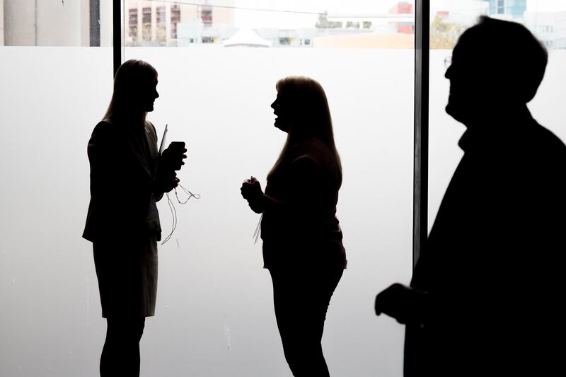 The silhouettes of attendees are seen as they speak outside a conference room during the Mobile World Conference Americas event in San Francisco, California, U.S., on Wednesday, Sept. 13, 2017. Leaders from the mobile ecosystem will be presenting the challenges and opportunities in the industry and the impact it has on society. Photographer: David Paul Morris/Bloomberg