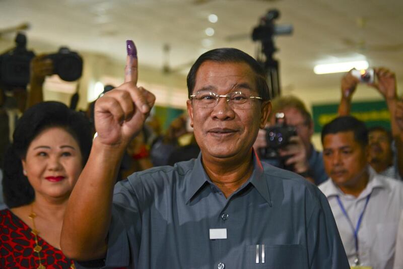 Cambodia’s longest-serving prime minister Hun Sen at a polling station in Kandal province during the general election last year, showing the indelible ink on his finger that is used to indicate that he has cast his vote. Kimlong Meng / Demotix / Corbis