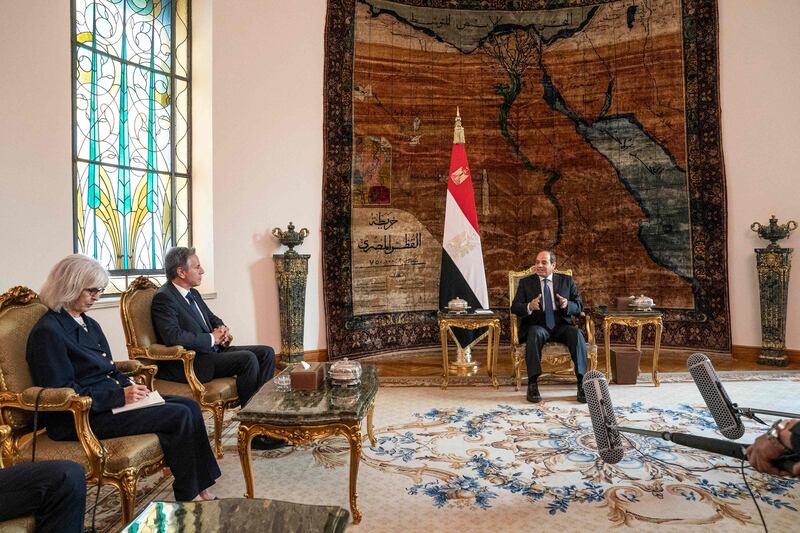 Egypt's President Abdel Fattah El Sisi, right, meets with Mr Blinken, centre, in Cairo. AFP