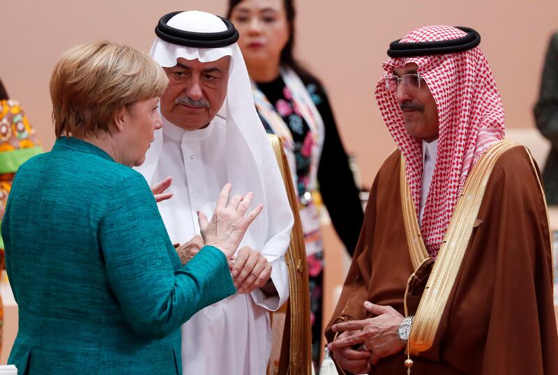 German chancellor Angela Merkel talks to Saudi Arabia's former finance minister Ibrahim Al Assaf, centre, and the current finance minister Mohammed Al Jadaan on July 8, 2017, the second day of the G20 summit in Hamburg, Germany. Felipe Trueba / EPA