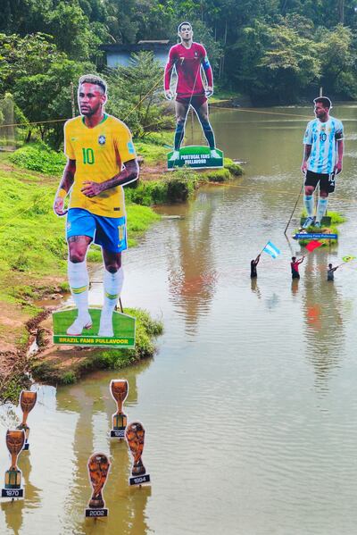 Cutouts of footballers, Brazil's Neymar, left, Portugal's Cristiano Ronaldo, centre, and Argentina's Lionel Messi, placed by football fans in the Cherupuzha river, in Kozhikode, Kerala. AFP