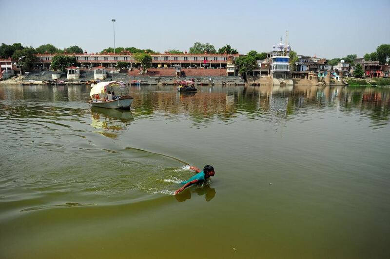 An Indian youth swims in the polluted waters of the river Ganges at Sarsaiya Ghat in Kanpur on June 26, 2014. Sanjay Kanojia/AFP Photo