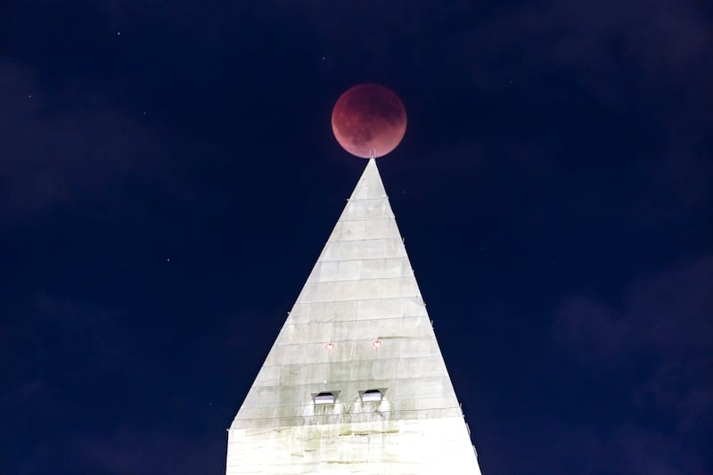The 'Super Flower Blood Moon' lunar eclipse was visible for only a few moments above the Washington Monument in Washington, DC. EPA