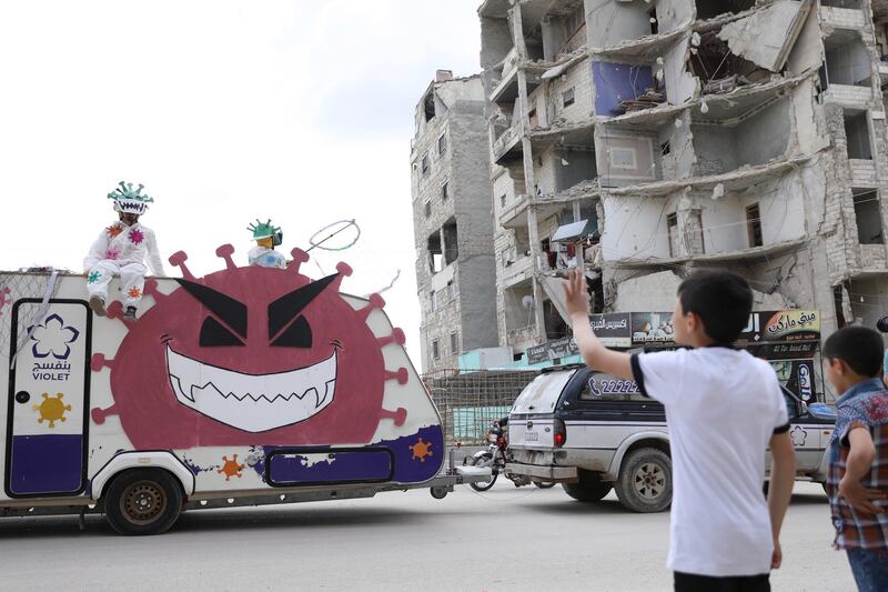 epa08392436 A truck for prevention against the COVID-19 coronavirus disease, operated by local NGO 'Violet Organization', drives through the streets of Idlib, Syria, 29 April 2020.  EPA/YAHYA NEMAH