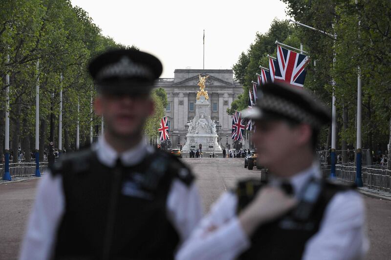 Police stand guard outside Buckingham Palace in London on Saturday. AFP