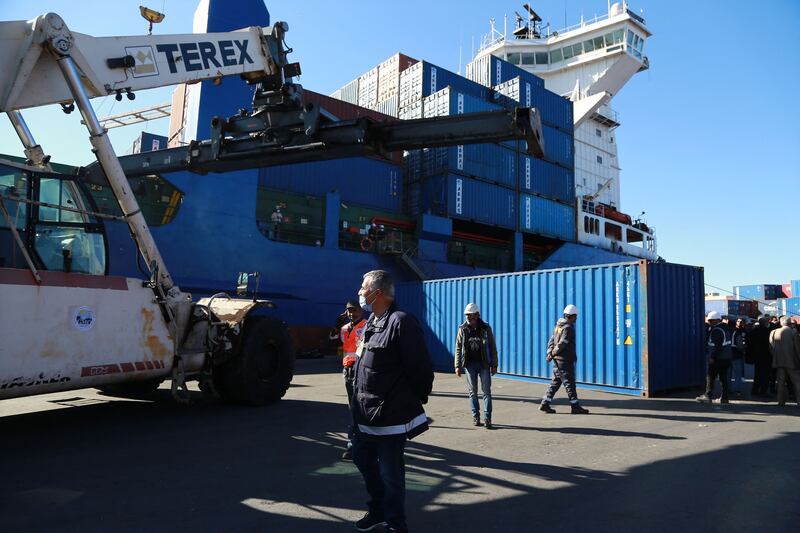 Containers filled with Italian waste illegally imported into Tunisia are loaded onto a ship.