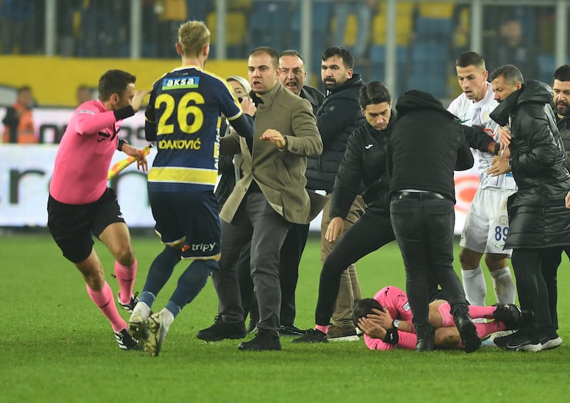 Referee Halil Umut Meler on the ground after being attacked. Reuters