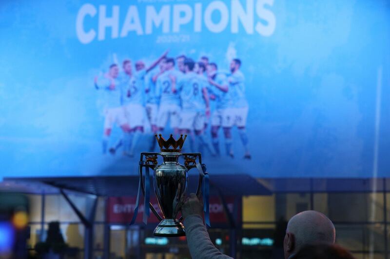 Fans celebrate at the Etihad Stadium after Manchester City were crowned Premier League champions. PA