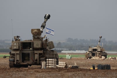 Israeli army tanks stand opposite the border with the Gaza Strip in southern Israel. AFP