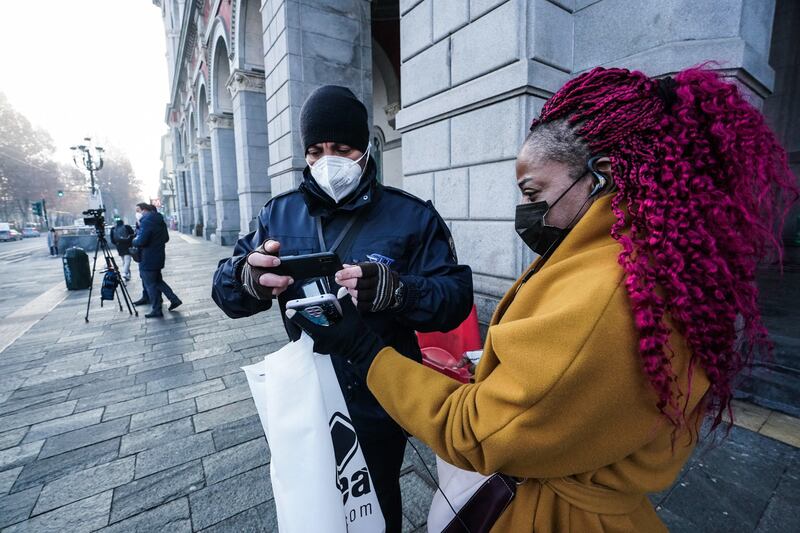 Traffic police check the green pass of public transport passengers in Turin, Italy. EPA