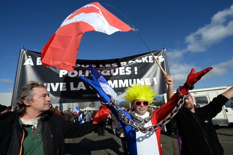 Freedom Convoy members, who have been inspired by a lorry drivers' protest movement in Canada, pose with a Canadian flag during a stop in Le Mans, western France. AFP