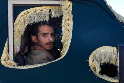 A Houthi fighter in Sanaa, Yemen looks through a window of a vehicle carrying the coffin of a comrade killed in recent US-UK air strikes on rebel sites. EPA