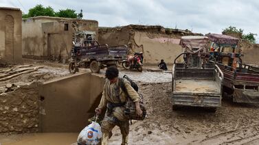 A man walks through a mud-covered street after a flash flood in Laqiha village, in Afghanistan's Baghlan province.  AFP