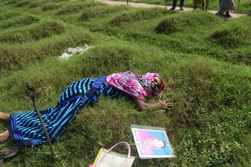 Bangladesh mother, Nazma Begum, grieves at the grave of her garment worker daughter Aakhiat, who was identified through DNA matching as a victim of Bangladesh’s Rana Plaza factory collapse. Munir uz Zaman / AFP