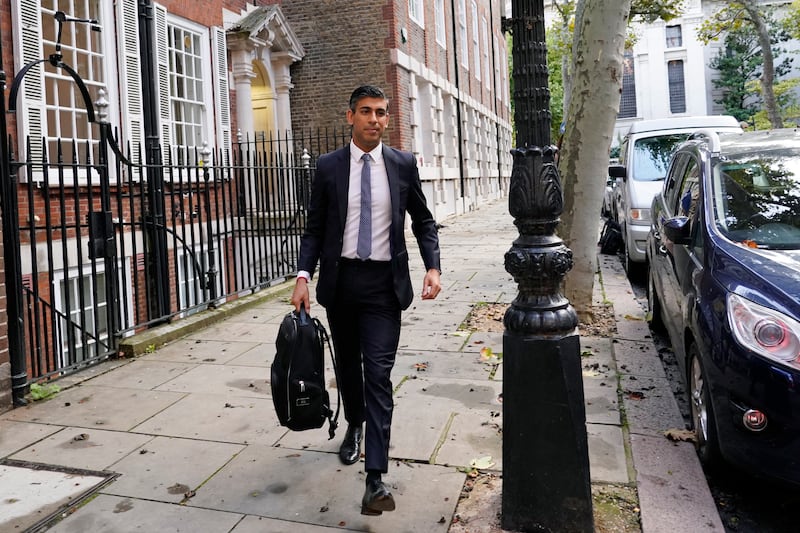 Mr Sunak leaves his campaign office in London. AP