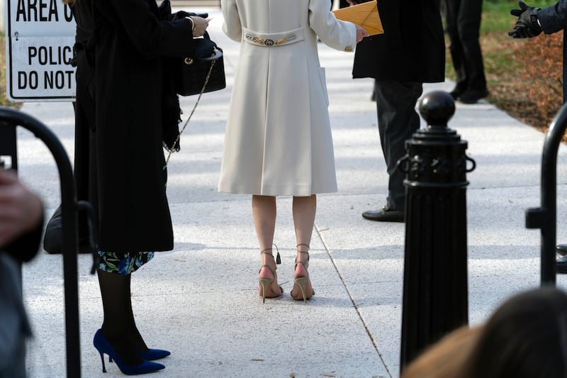Guests began arriving at the security checkpoint hours before the ceremony, including women in open-toed shoes despite the chill. AP
