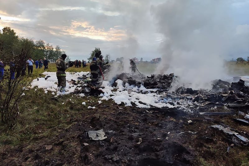 Russian authorities attend the site of the plane crash. AFP
